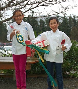 Sabrina Bailey and Millie Kau show off their "Best Overall" prizes and ribbons in the K-5 competition.