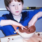 5th grader Avery Bishop-Martin smooths the edges of his bowl.