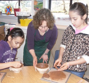 Penny helps students, Soeth Quintero and Jeiri Velazquez make their bowls from scratch.