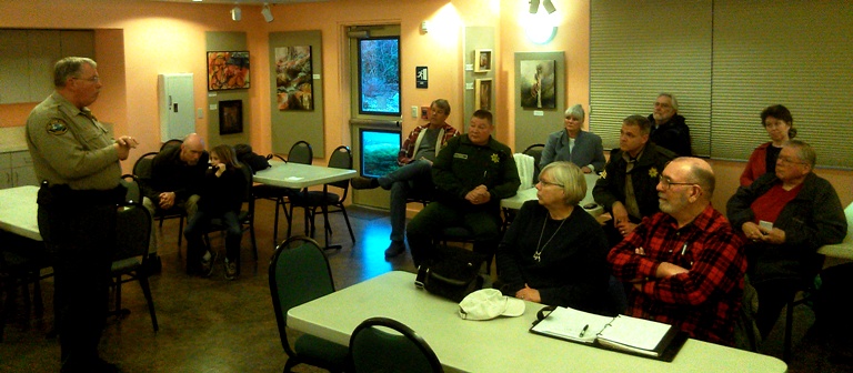 Far left, Undersheriff Bruce Distler discusses a wide range of topics under the heading of "safety" at the first of a planned series of Meet Your Deputies gatherings of Sheriff's officers and the public