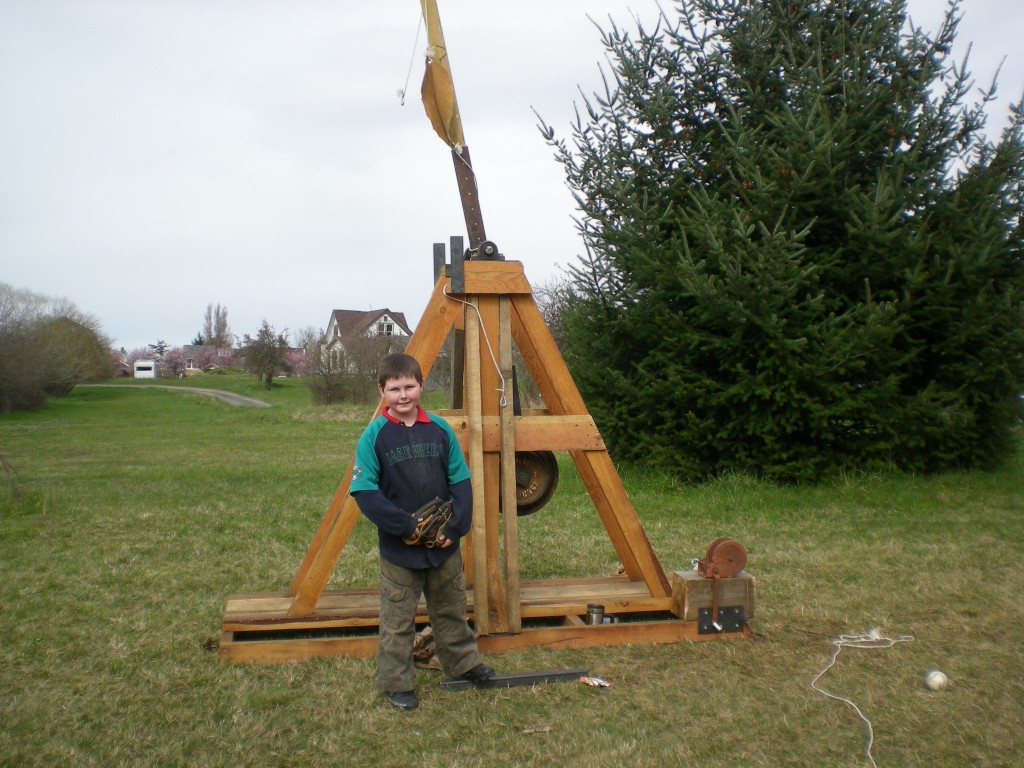 Aidan McCormick stands in front of the trebuchet made with his brother and friends under the direction of their father. They won first prize in the 2011 Science Fair
