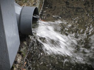 Water pours from the drain pipe at Templins Square. Photo: Lin McNulty