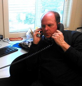 County Council member Rick Hughes in teleconference on Friday by landline and cell phone. Photo: Margie Doyle