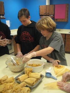 Ivan Bullock and Kellen Maier finishing up the chicken.