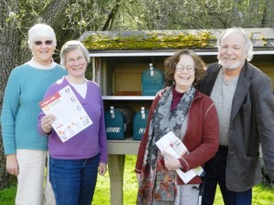 Watch your mailbox! Holding a preview copy of OPAL’s first “Report to the Community” is OPAL Executive Director Lisa Byers. Joining her are (left to right) Helen Bee, OPAL trustee; Penny Sharp Sky, OPAL co-founder and trustee; and Allen Smith, president of the OPAL board.