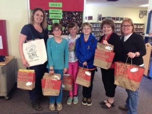 Pictured with books from Darvills: Brook Meinhardt, Izie Janecek,Hazel Meinhardt Moe, Henry Meinhardt Moe, Susan Stolmeier, and Janet Brownell (OIEF)