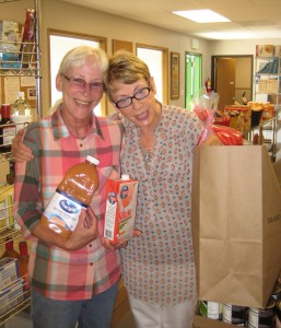 Food Bank Manager, Jeannie Doty, and volunteer  Joanne Cundy pack bags for Senior Outreach deliveries.