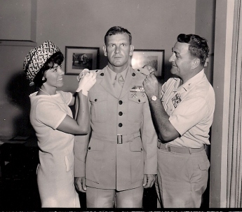 John Erly becomes an officer, flanked by his wife Marilyn and his Commanding General