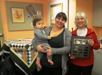 Maggie Vinson holding her son Lincoln with Laurie Peth at the Historical Museum fundraiser