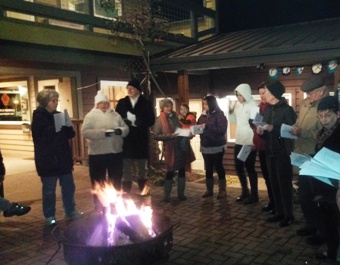 Carolers sing into the winter night