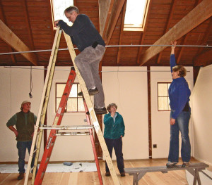 Charles Fast, Kevin Loomis, Molly Thomber and Tina Brown strategically install Artworks lighting fixtures