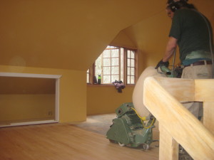 Putting the final touches on the beautiful wood floor in the Upstairs Gallery