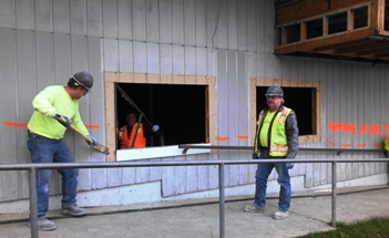 Tiger Construction builders now go to work on Phase II, the new library/cafeteria building, scheduled for completion by Sept. 2015