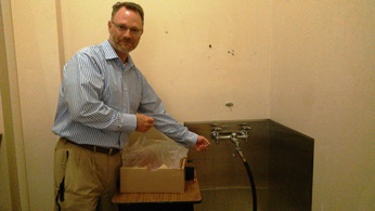 Superintendent Eric Webb points to the "culprit" faucet that was stuck on, causing the elementary school flood of thousands of gallons of water last weekend.