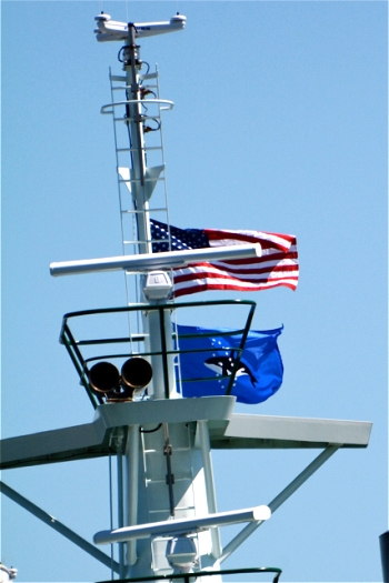 The unofficial flag of San Juan County flies under the National Flag. Photo courtesy Bill Pike