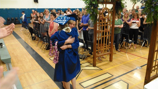 Two by Two, Orcas High School graduates greet each other before mounting the stage for Commencement Exercises