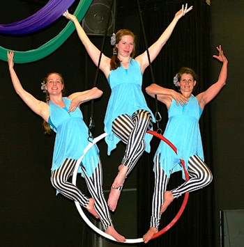 Aerial acrobatics with silks and hoops are part of the Magic Show