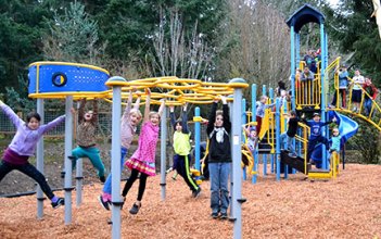 Kids play on the new playground at the Funhouse