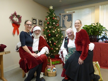 Arron Redford and Jami Mitchell tell Santa and Mrs. Claus that they've been very, VERY good at the Senior Center