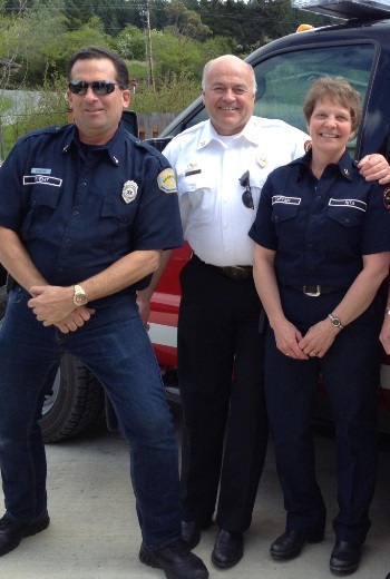 Orcas Fire and Rescue Chief Mik Preysz, flanked by Alan Stamiesen and Rita Harvey