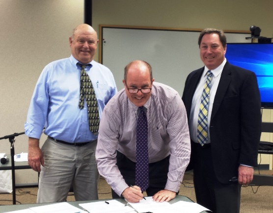 San Juan County Council members from left, Bob Jarman, Rick Hughes and Jamie Stephens sign the Shoreline Master Program on April 5, 2016 at the Eastsound Fire Hall