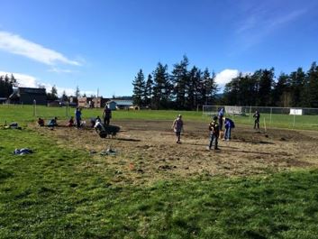 Volunteers help get the Buck Park fields ready this spring