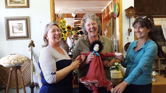 Susan Malins, center, in Score! Nifty Thrifty refereeing Colleen Billings, left, and Anita Orne, right, at the start of the Thank You Orcas sale