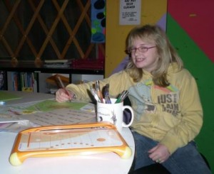 Alexis Pence starts her book, "All About Me" at the free art class meeting Tuesdays and Thursdays