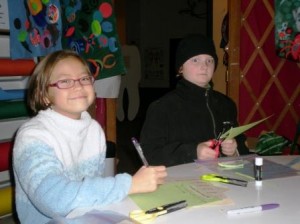 Sabrina Bailey and Isaac Clark make their journals at the Funhouse's Yurt Hut