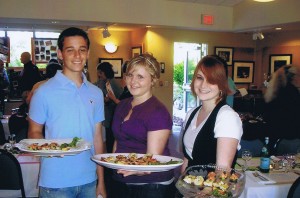 Dylan Holmes, Ashlee Minnis and Rebecca Lucas, all Kaleidoscope alumni, serve at last year's Island Raised, Island Grown dinner