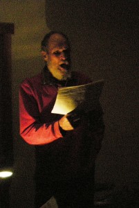 Orcas A Cappella bass Stan Miller rehearses his madrigal song by lamplight