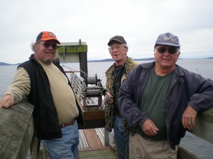 John Barnes, Tim Ordwing and Dale Mattson await the return of the Olga dock.