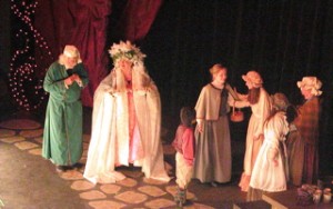 Scrooge (Gabriel Olmsted) and Christmas Present (Susan Osborn) look on as the Cratchit Family celebrate their meager Christmas. 2006 photo courtesy of Margot Shaw.