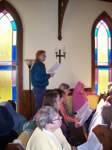 Caroline Scott rehearses "Encores" selections with other Orcas a Cappella singers at the Victorian Valley Chapel earlier this year.