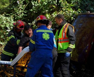 Michael HInton is assisted from his vehicle by Orcas Fire Department. Photo by Lee Pollard.