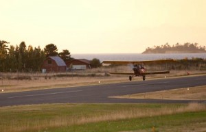 Rod Magner's biplane comes in for a landing at the Orcas airport. Photo courtesy of Alex Huppenthal