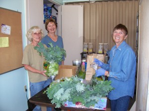 Jeannie Doty, Maria Webster and Jan Koltun helped get fresh produce on the shelves.