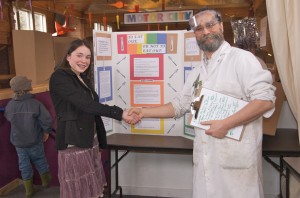 Grace Thompson wins first place award for her project on bacteria. She is shown here with Funhouse Wizard Gregory Books.