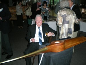 Harry Patton, with a World War II wooden airplane propeller, presented to him at the annual airmen's banquet.