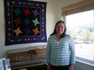 Hilary Canty, Executive Director of the Orcas Island Community Foundation, stands in the new office across Prune Alley from Island Market.