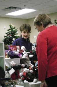 Lynn Thomerson helps a visitor to her booth at the Senior Center's Holiday Festival, on Nov. 28 this year