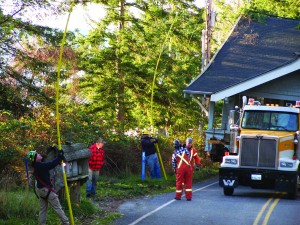 OPALCO crews assist in moving house from barge at Obstruction Pass to Olga