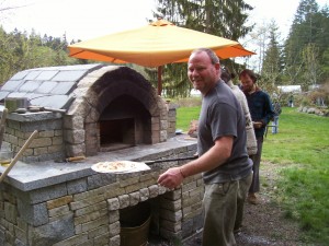 John Steward, hard at work at the pizza oven at Maple Rock Farm