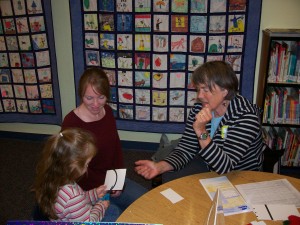 Deja Massey with her mom Alysha at the kindergarten screening in the Orcas school library.