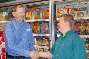 Mark Larson congratulates Jason Linnes on the completion of energy upgrades and Island Market’s leadership in energy efficiency. Contributed photo