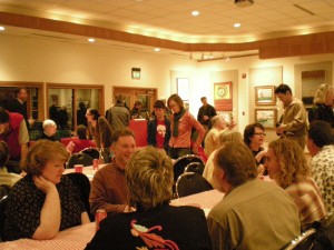 Crowds pack the Orcas Center's Madrona Room to enjoy art, wine and hamburgers on Friday night.