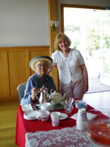 Joyce Burghardt serves tea with Karen Blinn inside the Emmanuel Church Parish Hall