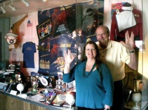 Karen and Ken Speck give the Star Trek salute in front of the display of their collection, on display this week at the Seaview Theater. (How do they do that?)