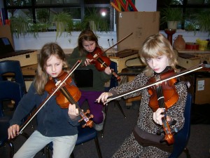 Olivia Brunner-Gaydos, Joanne Mietzner and Bethany Hansen rehearse for tonight's concert.